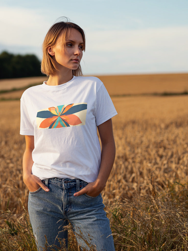 Woman wearing a lucenza fiore white t-shirt with a colorful abstract design in a field