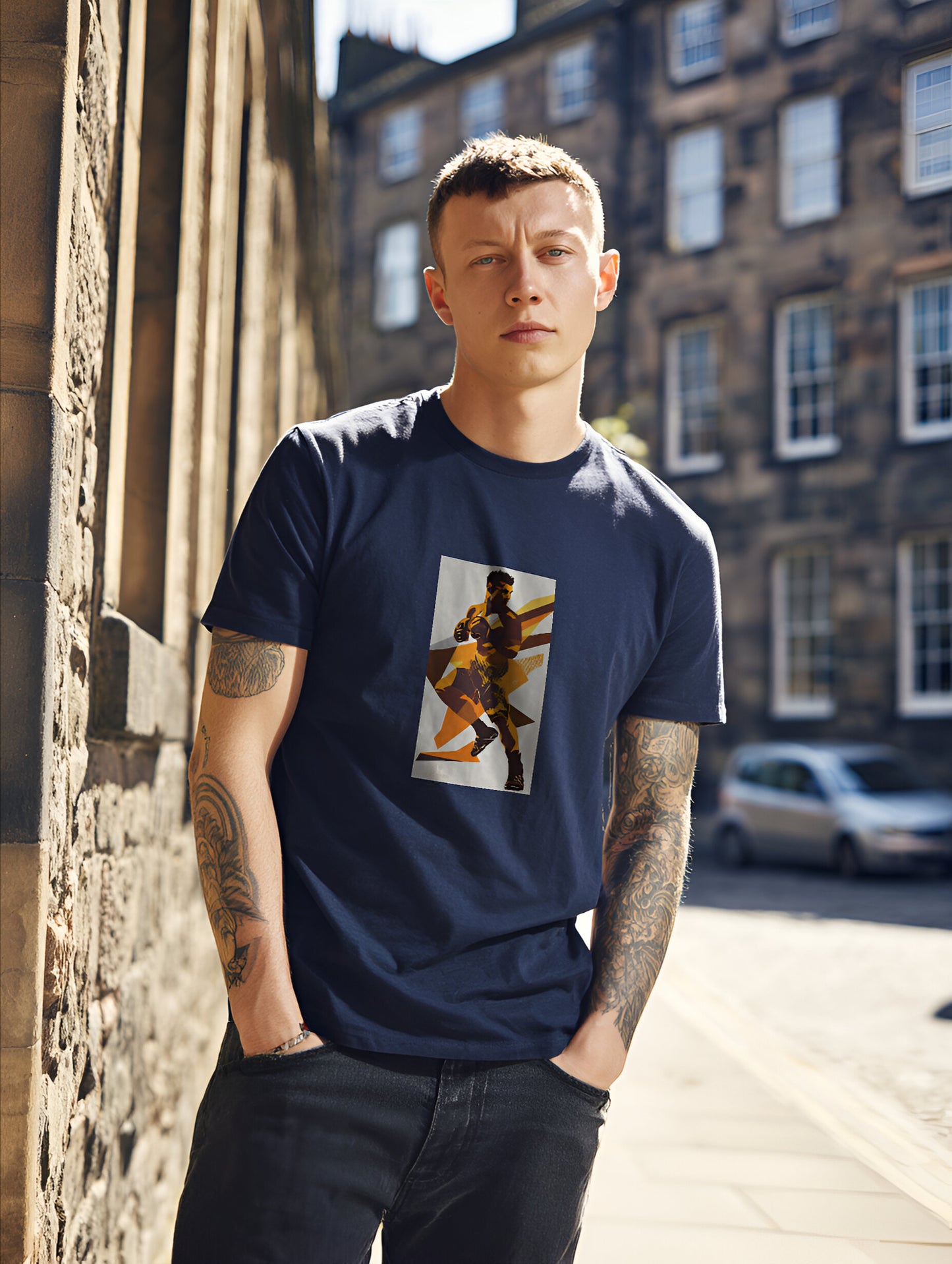 Man wearing a navy blue t-shirt with an mma graphic design, standing on a street.